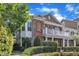 A beautiful brick townhouse featuring a cozy balcony and lush greenery, offering a welcoming curb appeal at 10511 Sablewood Dr # 107, Raleigh, NC 27617