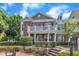 Brick townhouse featuring a second-story balcony and well-maintained landscaping at 10511 Sablewood Dr # 107, Raleigh, NC 27617