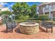 Exterior view shows a central fire pit surrounded by benches in a brick patio area at 10511 Sablewood Dr # 107, Raleigh, NC 27617