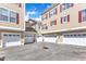 Exterior view shows multiple attached garages in a courtyard with red shutters at 10511 Sablewood Dr # 107, Raleigh, NC 27617