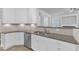 Modern kitchen with granite countertops, white cabinetry, and stainless steel appliances at 10511 Sablewood Dr # 107, Raleigh, NC 27617