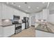 Modern kitchen with white cabinetry, stainless steel appliances, and granite countertops at 10511 Sablewood Dr # 107, Raleigh, NC 27617