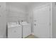 Functional laundry room with appliances, shelving, and a door to the exterior at 10511 Sablewood Dr # 107, Raleigh, NC 27617