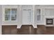Bright living room with gleaming hardwood floors, white trim, and a cozy fireplace at 10511 Sablewood Dr # 107, Raleigh, NC 27617