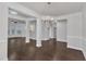 Open-concept living area with gleaming floors, a stylish chandelier, and bright windows at 10511 Sablewood Dr # 107, Raleigh, NC 27617