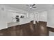 Open-concept living space with hardwood floors connecting the kitchen and dining area at 10511 Sablewood Dr # 107, Raleigh, NC 27617