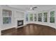 Cozy living area featuring a fireplace, ceiling fan, and large windows for ample natural light at 10511 Sablewood Dr # 107, Raleigh, NC 27617