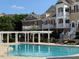 Community pool with lounge chairs and covered seating areas, set among landscaped grounds at 10511 Sablewood Dr # 107, Raleigh, NC 27617