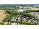 Aerial view showcases townhouse community near ample parking, surrounded by trees, with easy highway access at 1076 Kelso Ln, Burlington, NC 27215