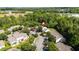 Aerial view of a residential community featuring well-maintained landscaping, parking, and mature trees at 1076 Kelso Ln, Burlington, NC 27215
