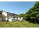 Spacious backyard featuring a play set, lush lawn, privacy fence, and storage sheds at 1076 Kelso Ln, Burlington, NC 27215