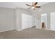 Spacious bedroom featuring carpet, ceiling fan, double closets, and an attached bathroom at 1076 Kelso Ln, Burlington, NC 27215