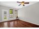 Cozy bedroom with ceiling fan, wood floors, and natural light from the windows at 1076 Kelso Ln, Burlington, NC 27215