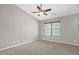 Bright bedroom featuring a large window with blinds and a ceiling fan, providing ample natural light at 1076 Kelso Ln, Burlington, NC 27215