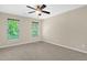 Comfortable bedroom featuring carpeted floors and sunlit windows with outside view at 1076 Kelso Ln, Burlington, NC 27215