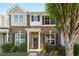 Charming brick townhome with a covered entryway and well-manicured landscaping at 1076 Kelso Ln, Burlington, NC 27215