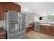 Spacious kitchen with stainless steel refrigerator, sink, and dark wood cabinets at 1076 Kelso Ln, Burlington, NC 27215