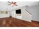 Open living room showcases hardwood floors, a TV, and easy access to the kitchen at 1076 Kelso Ln, Burlington, NC 27215