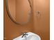 Stylish powder room featuring a modern sink, mirror, and freshly painted walls at 1076 Kelso Ln, Burlington, NC 27215