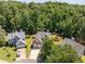 Aerial view of a home with well-manicured lawn, trampoline, and two-car garage at 110 Bonhill Ct, Apex, NC 27502