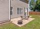 The backyard patio has a fire pit and dining table set, perfect for relaxing at 110 Bonhill Ct, Apex, NC 27502