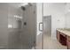 Bathroom showcasing a glass shower enclosure, tile floors, and double vanity at 110 Bonhill Ct, Apex, NC 27502