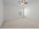 Well-lit bedroom with neutral carpet, overhead ceiling fan, and a single window at 110 Bonhill Ct, Apex, NC 27502