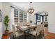 Dining room with view into the open floor plan and modern lighting fixture at 110 Bonhill Ct, Apex, NC 27502