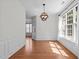 Bright dining room with hardwood floors, wainscoting, and large windows at 110 Bonhill Ct, Apex, NC 27502