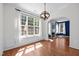 Lovely dining room featuring large windows, hardwood floors, and a fireplace at 110 Bonhill Ct, Apex, NC 27502
