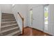 Inviting entryway with hardwood floors, staircase, and bright natural light at 110 Bonhill Ct, Apex, NC 27502
