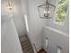 Bright foyer featuring an overhead chandelier, staircase and hardwood flooring at 110 Bonhill Ct, Apex, NC 27502