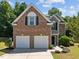 Charming two-story brick home featuring a two car garage and manicured front lawn at 110 Bonhill Ct, Apex, NC 27502