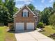 Inviting two-story brick home with a two-car garage and landscaped walkway at 110 Bonhill Ct, Apex, NC 27502