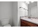 Stylish half bathroom with granite countertop, modern fixtures, and white walls at 110 Bonhill Ct, Apex, NC 27502