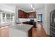 Modern kitchen with stainless appliances, granite countertops, and dark wood cabinets at 110 Bonhill Ct, Apex, NC 27502