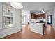 Spacious kitchen with stainless appliances and an island, flowing into a dining area at 110 Bonhill Ct, Apex, NC 27502