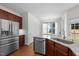 Modern kitchen featuring stainless steel appliances and a granite countertop island at 110 Bonhill Ct, Apex, NC 27502