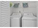 Bright laundry room with a side-by-side washer and dryer and plenty of storage at 110 Bonhill Ct, Apex, NC 27502