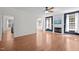 Open-concept living room featuring hardwood floors, a fireplace, and neutral decor at 110 Bonhill Ct, Apex, NC 27502