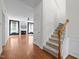 Spacious living room with hardwood floors, fireplace, and ample natural light at 110 Bonhill Ct, Apex, NC 27502