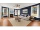 Living room with dark accent wall, fireplace, mantle, and natural light at 110 Bonhill Ct, Apex, NC 27502