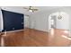 Spacious living room with hardwood floors, arched doorways, and blue accent wall at 110 Bonhill Ct, Apex, NC 27502