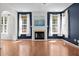 Bright living room featuring a fireplace, hardwood floors, and large windows at 110 Bonhill Ct, Apex, NC 27502
