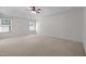 Spacious main bedroom featuring two windows, ceiling fan, and neutral carpet at 110 Bonhill Ct, Apex, NC 27502