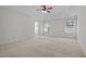 Spacious main bedroom featuring two windows, ceiling fan, and neutral carpet at 110 Bonhill Ct, Apex, NC 27502