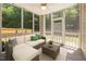 Relaxing screened porch with ceiling fan, comfortable seating, and backyard views at 110 Bonhill Ct, Apex, NC 27502