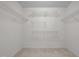 Spacious walk-in closet with white walls and multiple tiered shelving at 110 Bonhill Ct, Apex, NC 27502