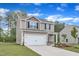 Charming two-story home featuring an attached two-car garage and beautifully landscaped front yard at 111 Rhino Bnd, Oxford, NC 27565