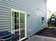 Back porch view with sliding glass door, grill and outdoor table and chairs at 1122 Birkdale Dr, Mebane, NC 27302